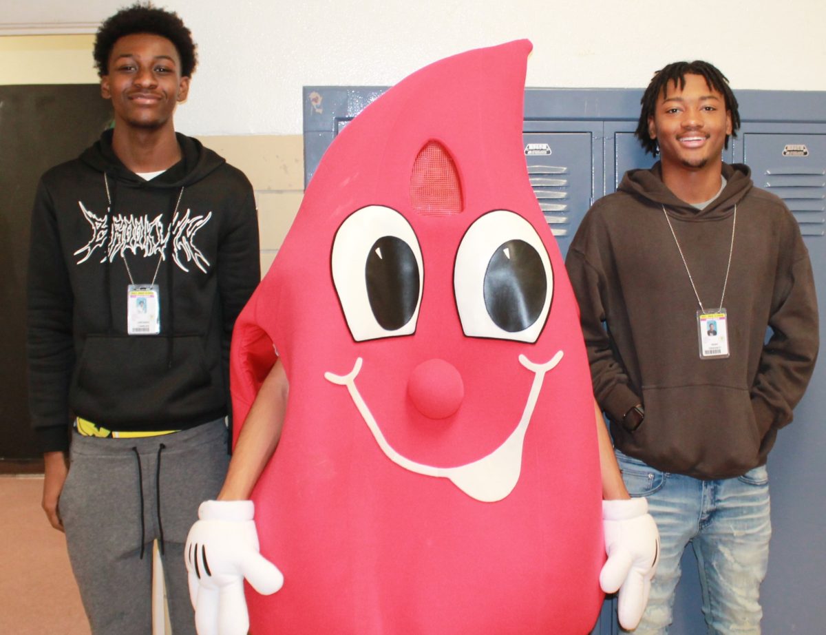 Blood drop Juan Estrada is joined by Quendez Charles, left, and Noah Crockett, right.